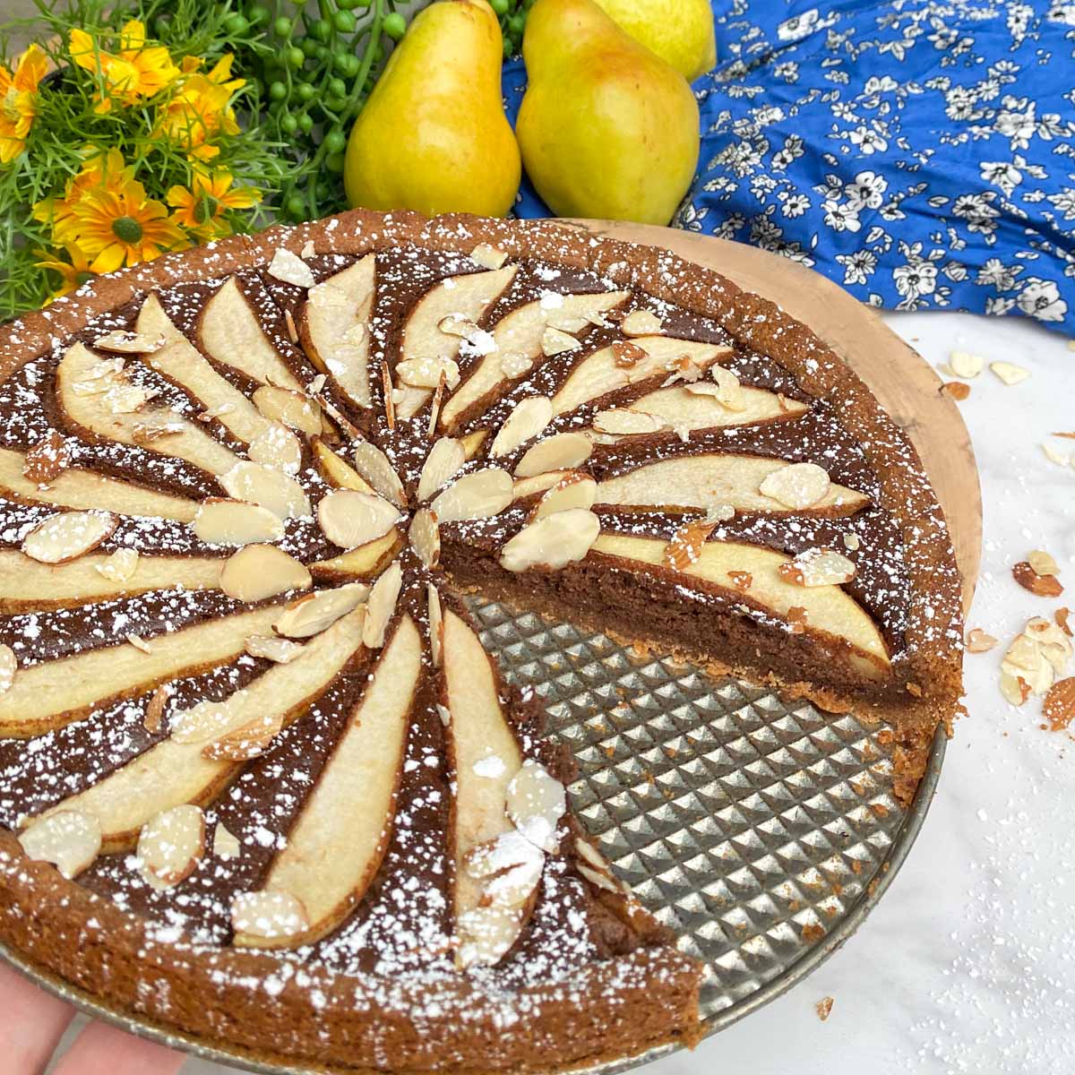 pear almond tart with slice missing