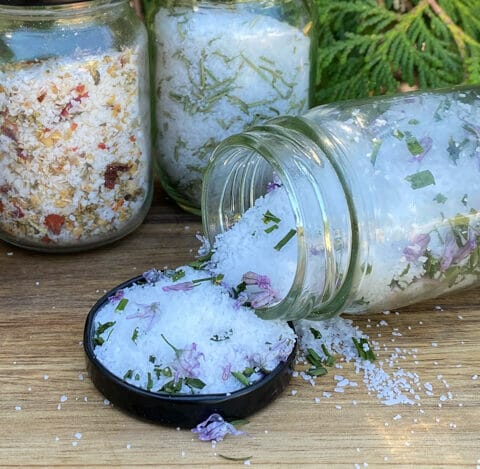 Chive finishing salt poured out of the jar in the lid with other flavours in the background.