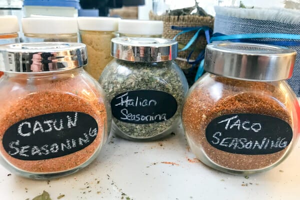 homemade seasoning blends in jars: cajun, italian and taco seasonings.