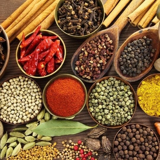 variety of spices including cinnamon, hot peppers, cloves, peppercorns, cardamom, curry, hot pepper flakes, bay leaves and others.