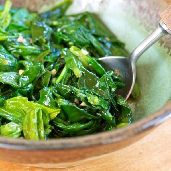 sauteed spinach with garlic in bowl with spoon
