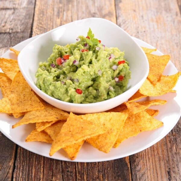 bowl of guac with chips around