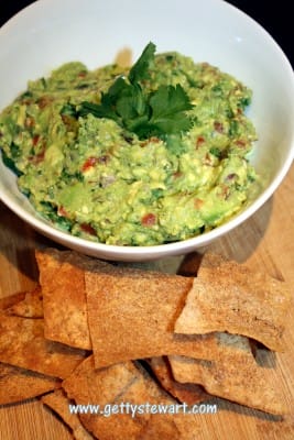 Fresh tasty easy guacamole with homemade baked pita chips