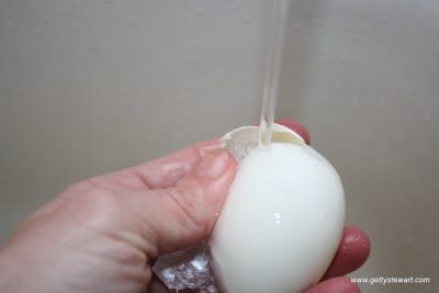 Peel an egg under running water for easier peeling