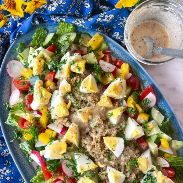 egg on quinoa and greens salad, topped with italian vinaigrette