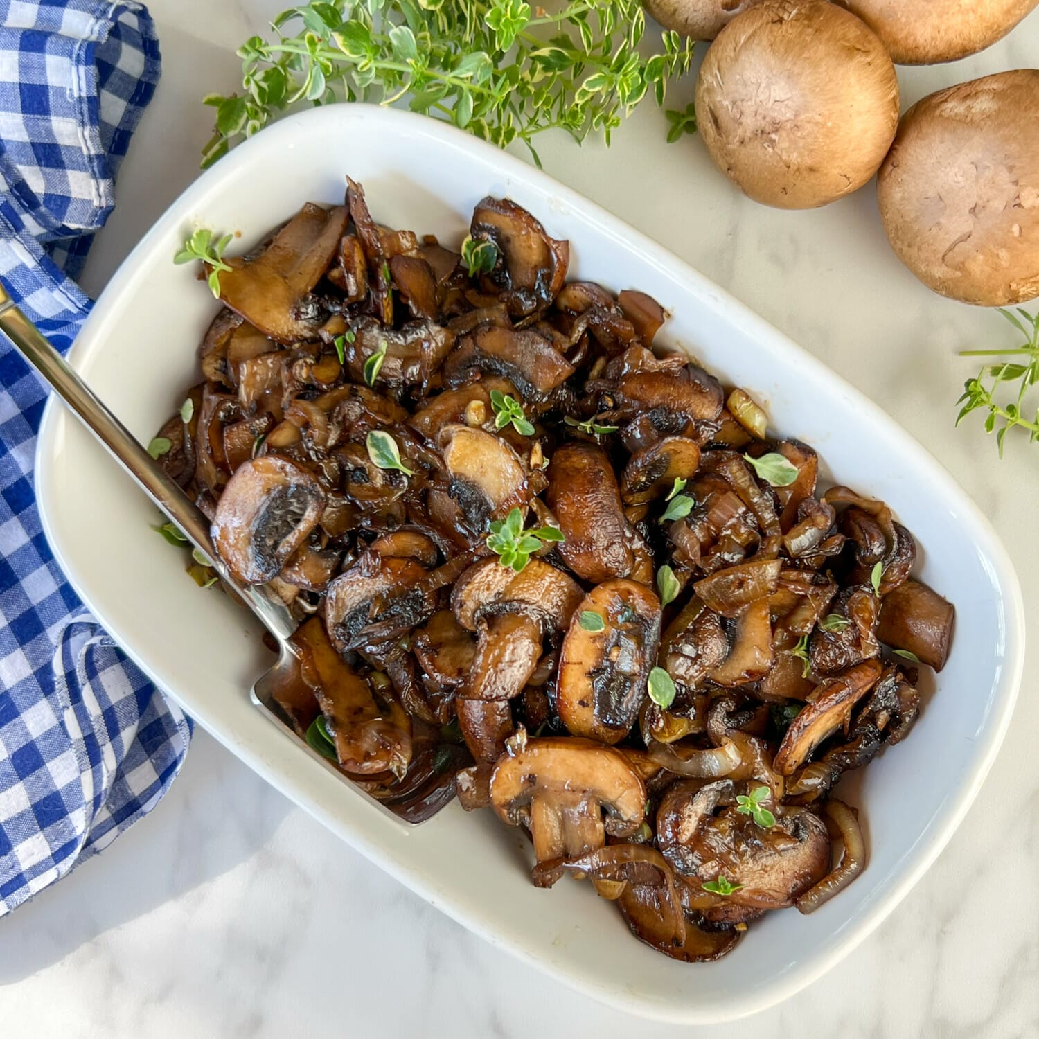  finished mushrooms and onions with herbs in serving dish