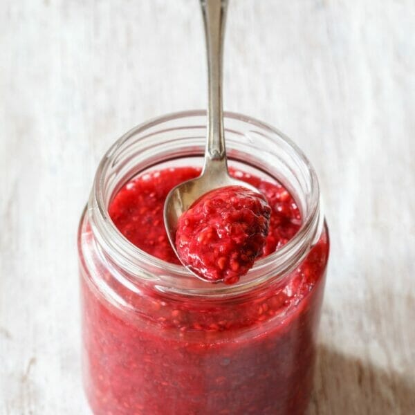raspberry chia seed jam in a ar with spoon