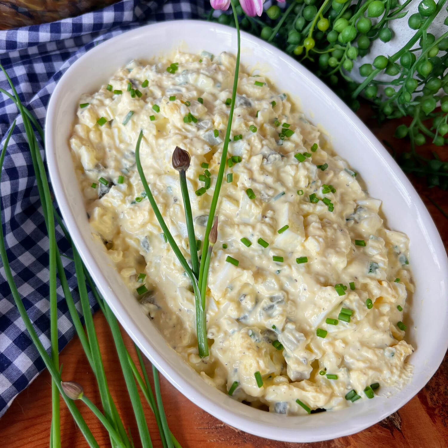 dish of egg salad with chives on top and beside