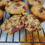 cranberry oat muffin on baking rack opened to see inside