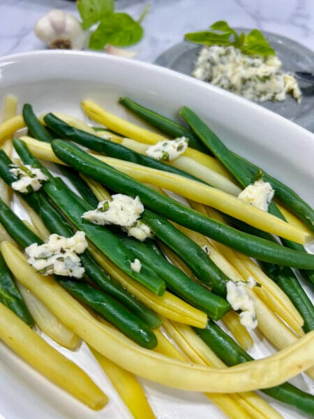 basil herb butter on green and yellow beans