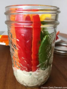 veggies and hummus in jar