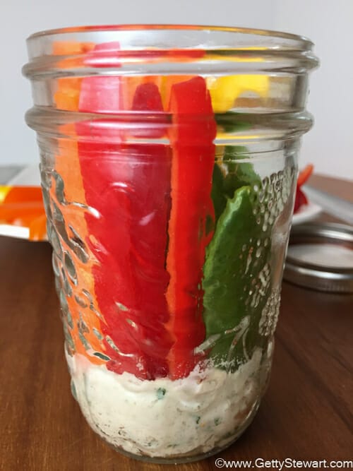 veggies and hummus in jar