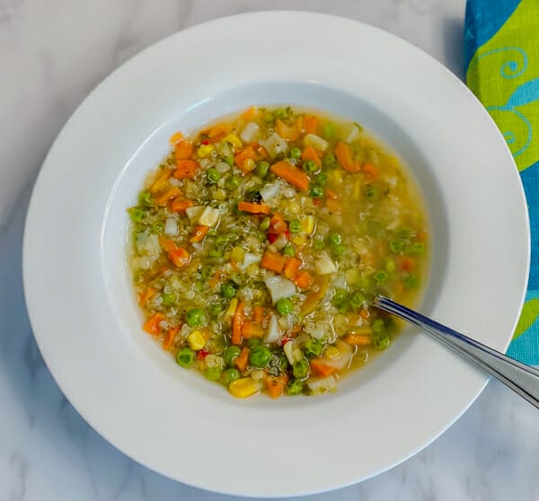 bowl of vegetable quinoa lentil soup prepared