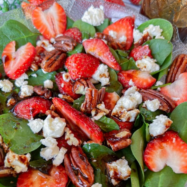 strawberry spinach salad with dressing, close up