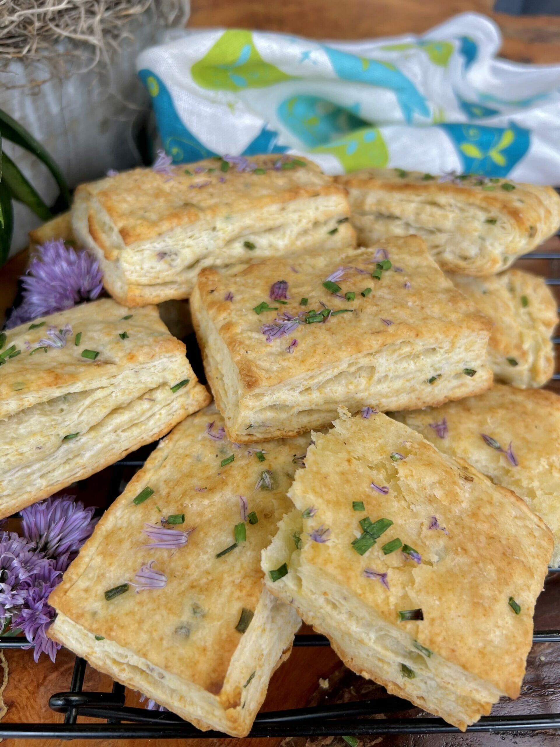 flaky chive biscuits in a pile one broken