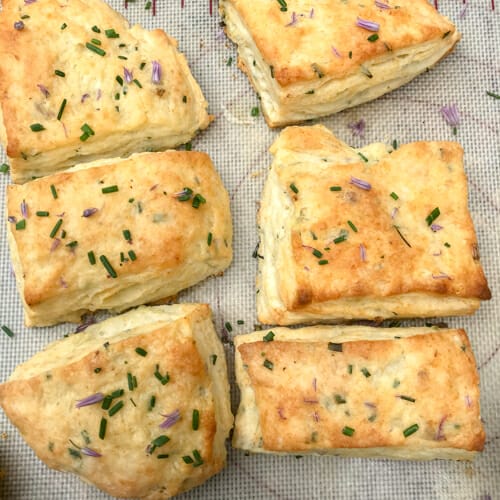 six chive biscuits on baking sheet
