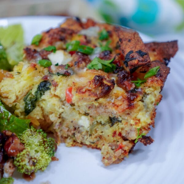 piece of breakfast strata on plate with salad