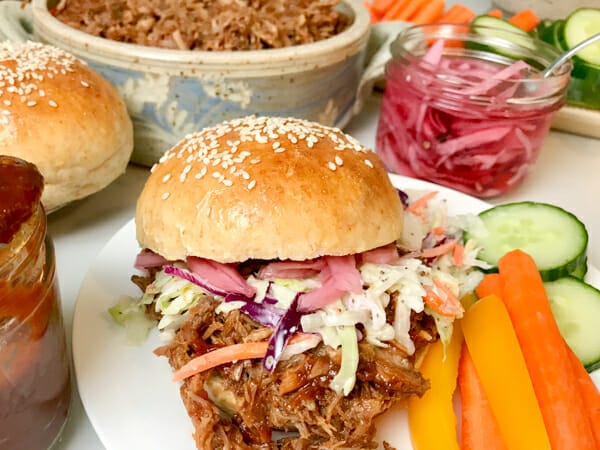 pickled red onion on pulled pork bun