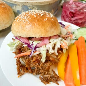pickled onion on pulled pork bun with slaw