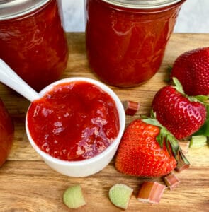 strawberry rhubarb jam in container on wood