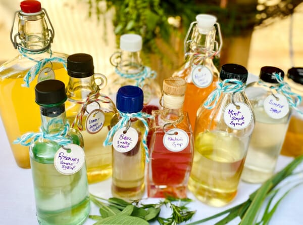 variety of herb infused simple syrup on table