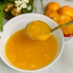 mandarin orange sauce in bowl with ladel