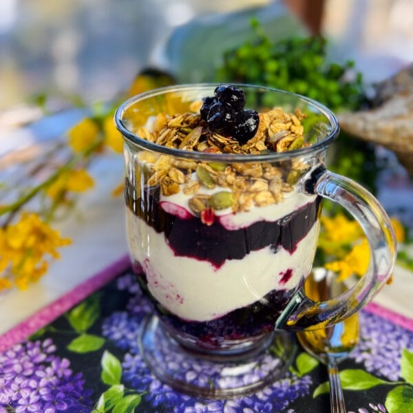 blueberry granola yogurt layered in a big glass cup