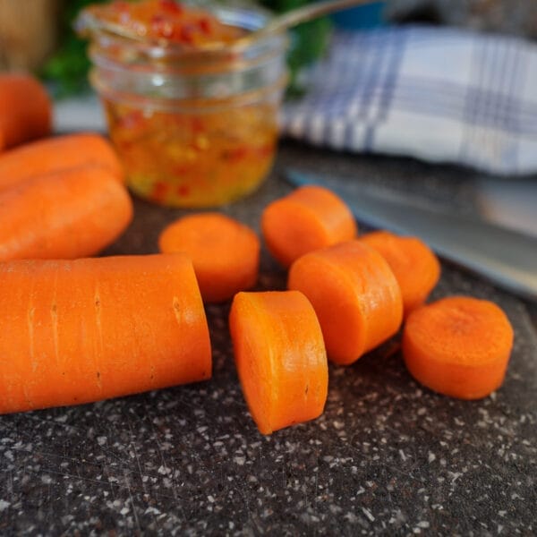 coin cut carrots on cutting board