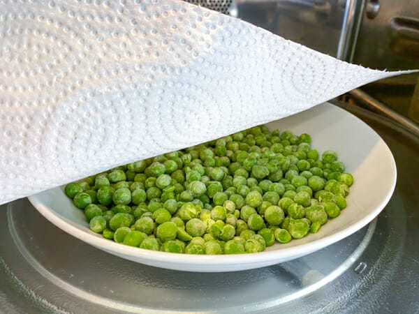 frozen peas in micro with paper towel cover