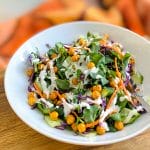 peashoot salad with chickpeas and labneh dressing on plate