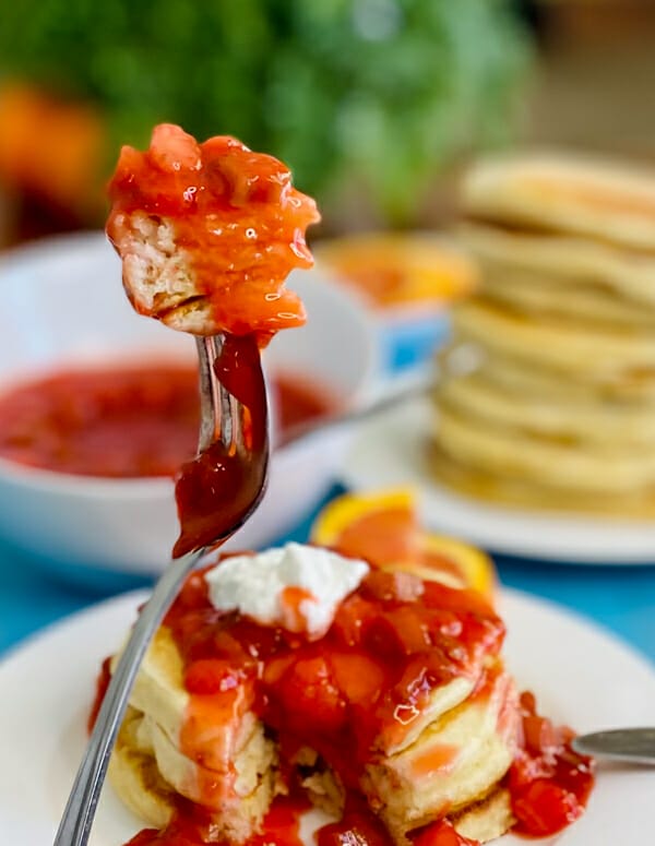 pancakes on fork with strawberry rhubarb sauce