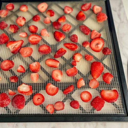 sliced frozen strawberries on tray