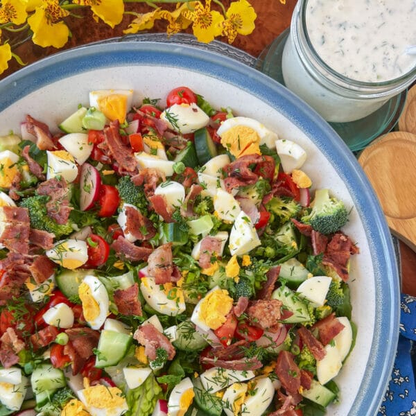 bacon and egg salad with ranch dressing in jar beside