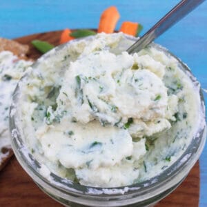 ricotta herb spread in bowl with spoon
