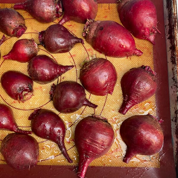 beets coated in oil on baking sheet