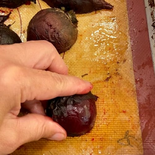 peeling roasted beets with fingers