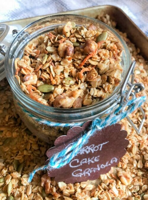 carrot cake granola in jar on baking sheet

