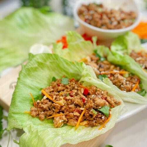 Close up of chicken lettuce wrap on board
