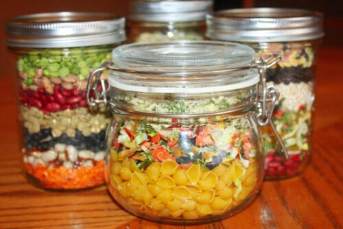 Chicken noodle soup mix in fancy jar with other dry ingredient mixed jars in the background.
