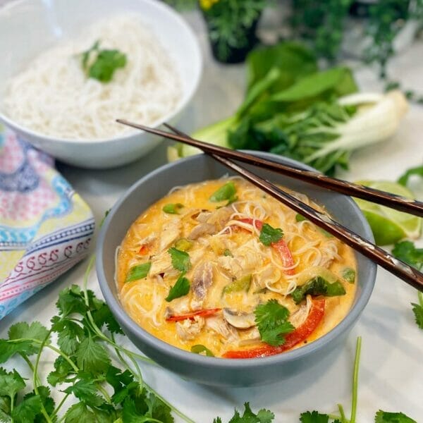 thai red curry soup bowl with chopsticks