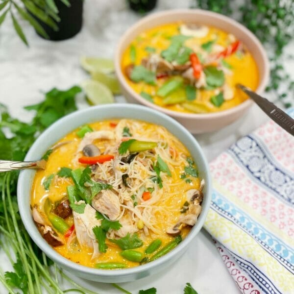 two bowls of thai red curry soup