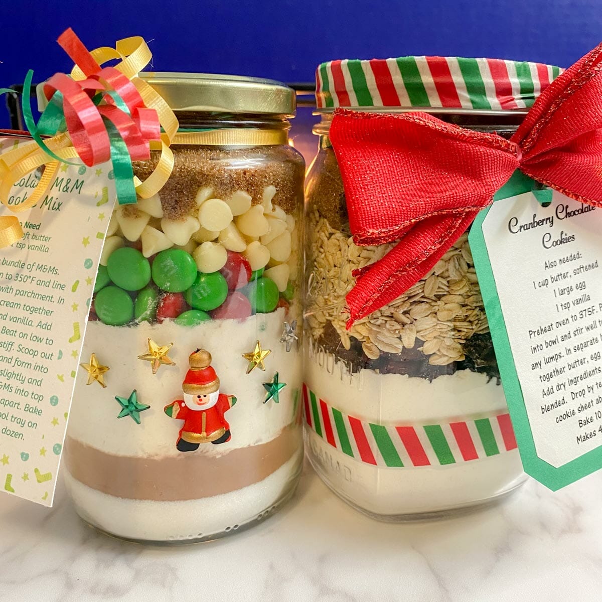 2 jars of cookie mixes with instruction/gift tags and decorative ribbon/bows.