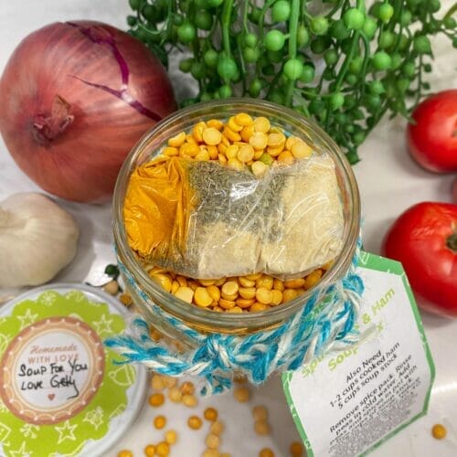 Shows how to pack the soup mix in the jar. Note: Spice pack on top of dry ingredients. Image has fresh veggies in the background.