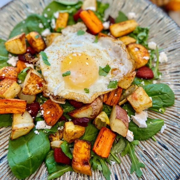 fried egg on root veggies and dark leafy greens
