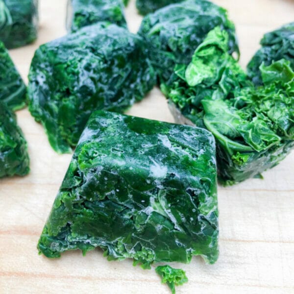 dark green and frozen blocks of kale, made using ice cube trays