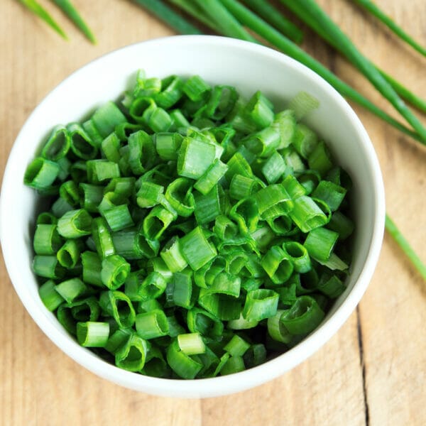 close up of chopped chives in bowl
