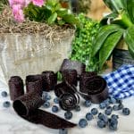 rolls of blueberry leather with blueberries