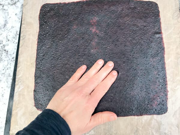 hand pressing on fruit leather