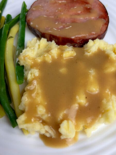close up of gravy on mashed potatoes