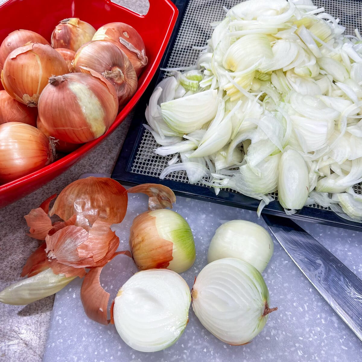 mix of whole, cut and sliced onions on cutting board with knife